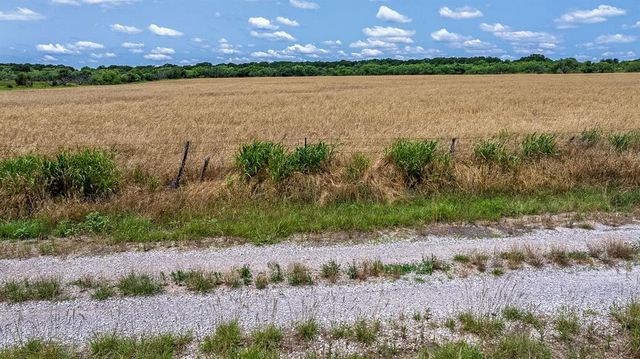 an aerial view of a houses with a yard