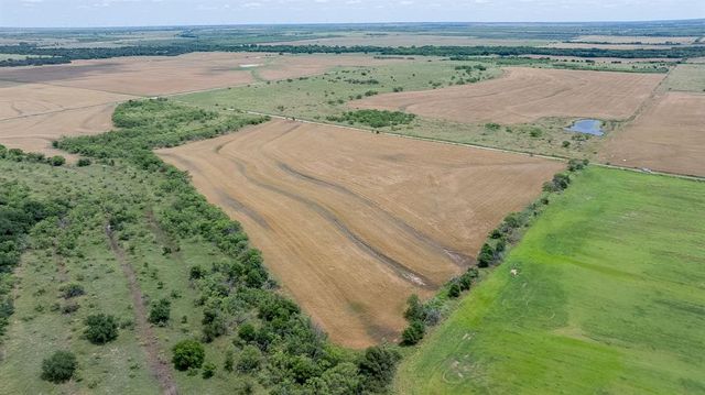an aerial view of a house with a yard and lake view