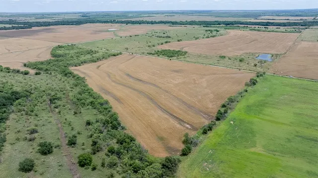 an aerial view of a house with a yard and lake view