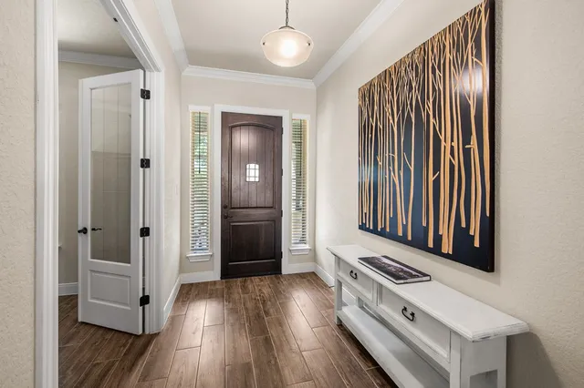 a view of a livingroom with wooden floor and staircase