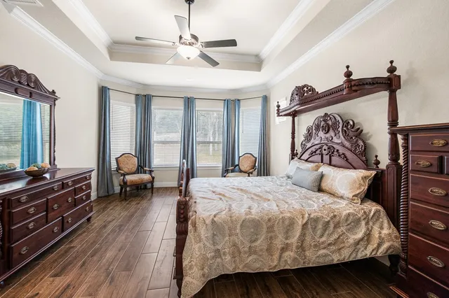 a bedroom with a bed and a chandelier