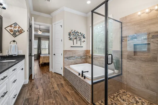 a spacious bathroom with a double vanity sink a mirror and a shower