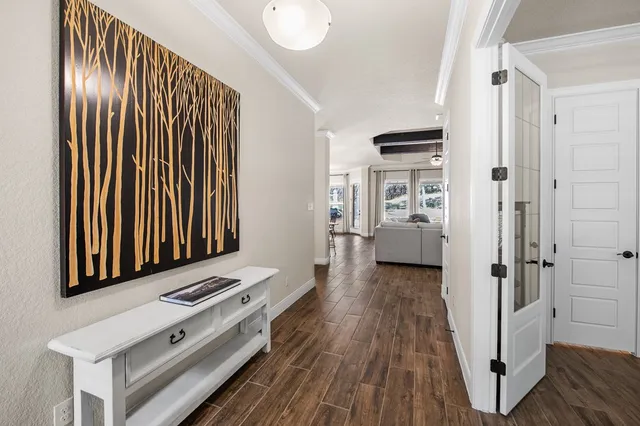 a view of a hallway with wooden floor and staircase