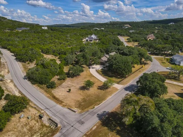 an aerial view of a house with a yard