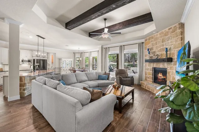 a living room with furniture a fireplace a potted plant and a fireplace