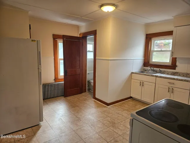 a kitchen with a stove and a refrigerator