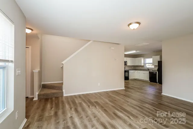a view of a kitchen with a sink and a refrigerator