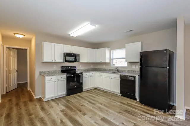 a kitchen with a refrigerator stove and sink
