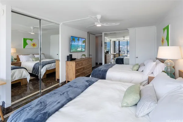 a bedroom with a bed window and couch