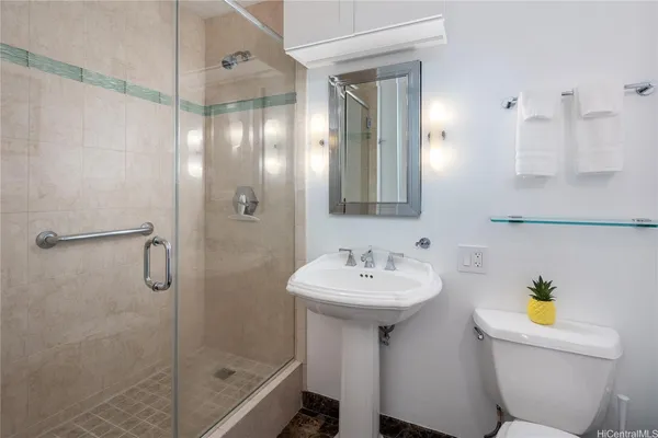 a bathroom with a sink toilet and shower