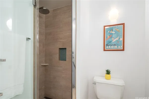 a bathroom with a toilet and a shower