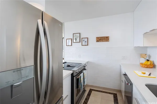 a kitchen with stainless steel appliances a refrigerator and a stove
