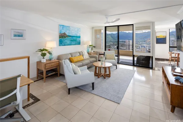 a living room with furniture and a floor to ceiling window