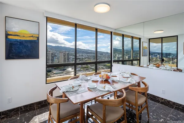 a dining room with furniture and a floor to ceiling window