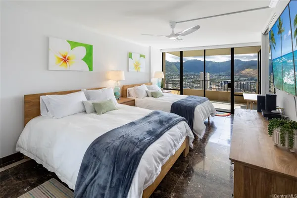 a bedroom with bed and a large window