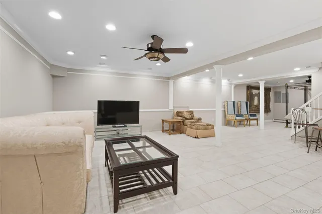 a living room with furniture and stairs
