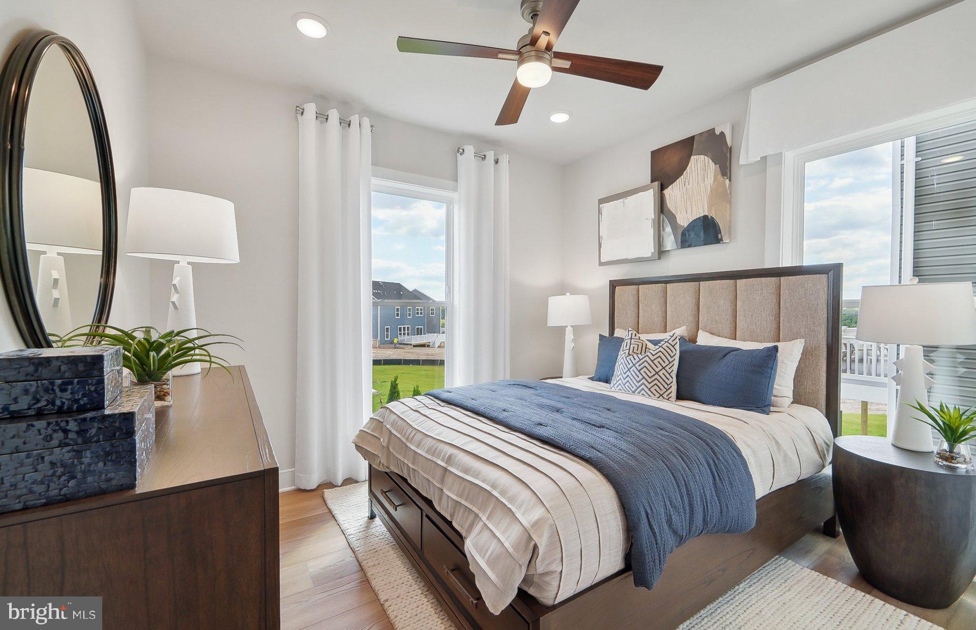 22512 Sculpin Brk Road Boyds, MD 20841 - Photo 17 of 69 a bedroom with a large bed and a chandelier