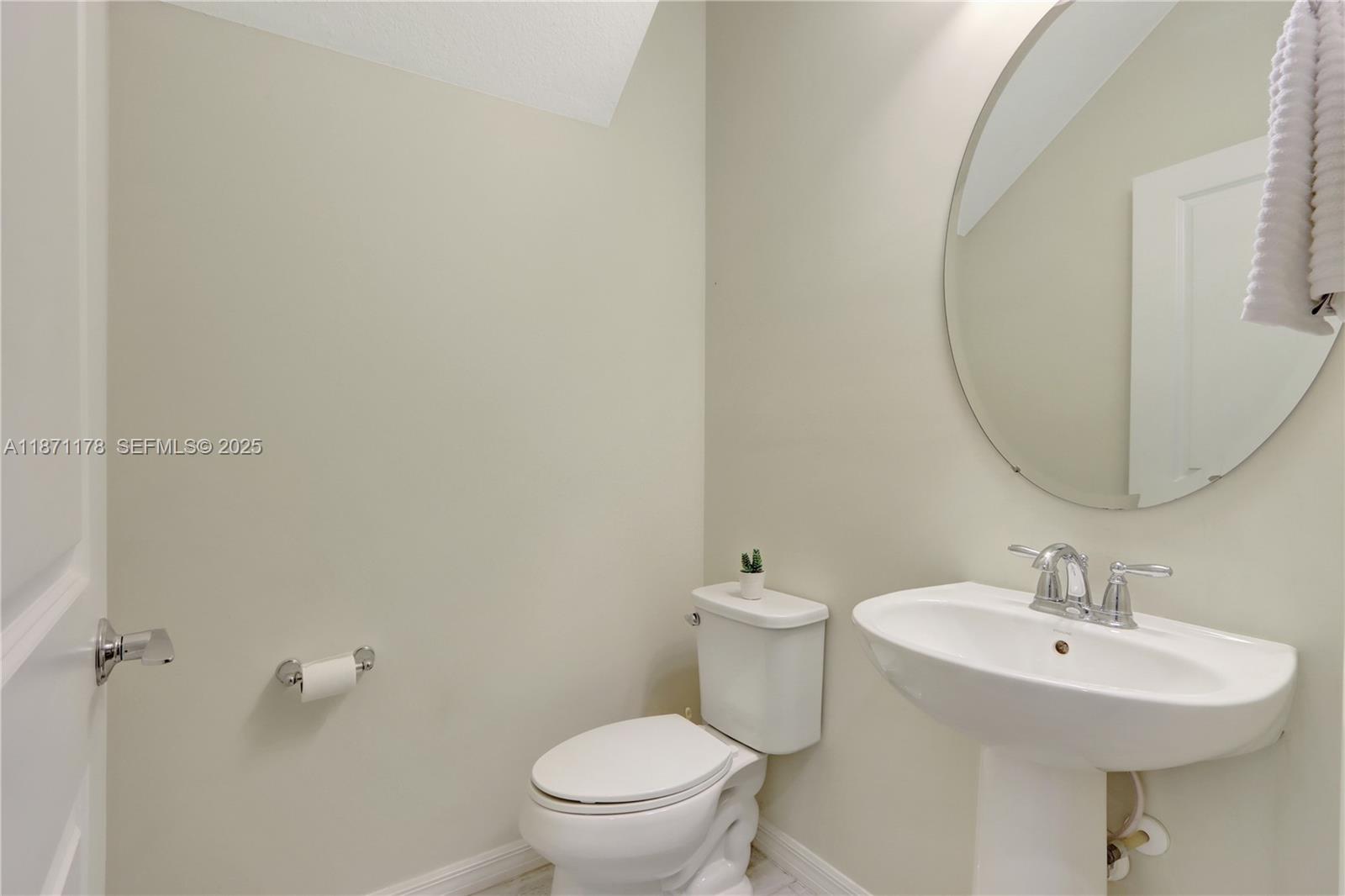 4353 Large Leaf Lane Hollywood, FL 33021 - Photo 13 of 31 a bathroom with a sink a toilet and a mirror