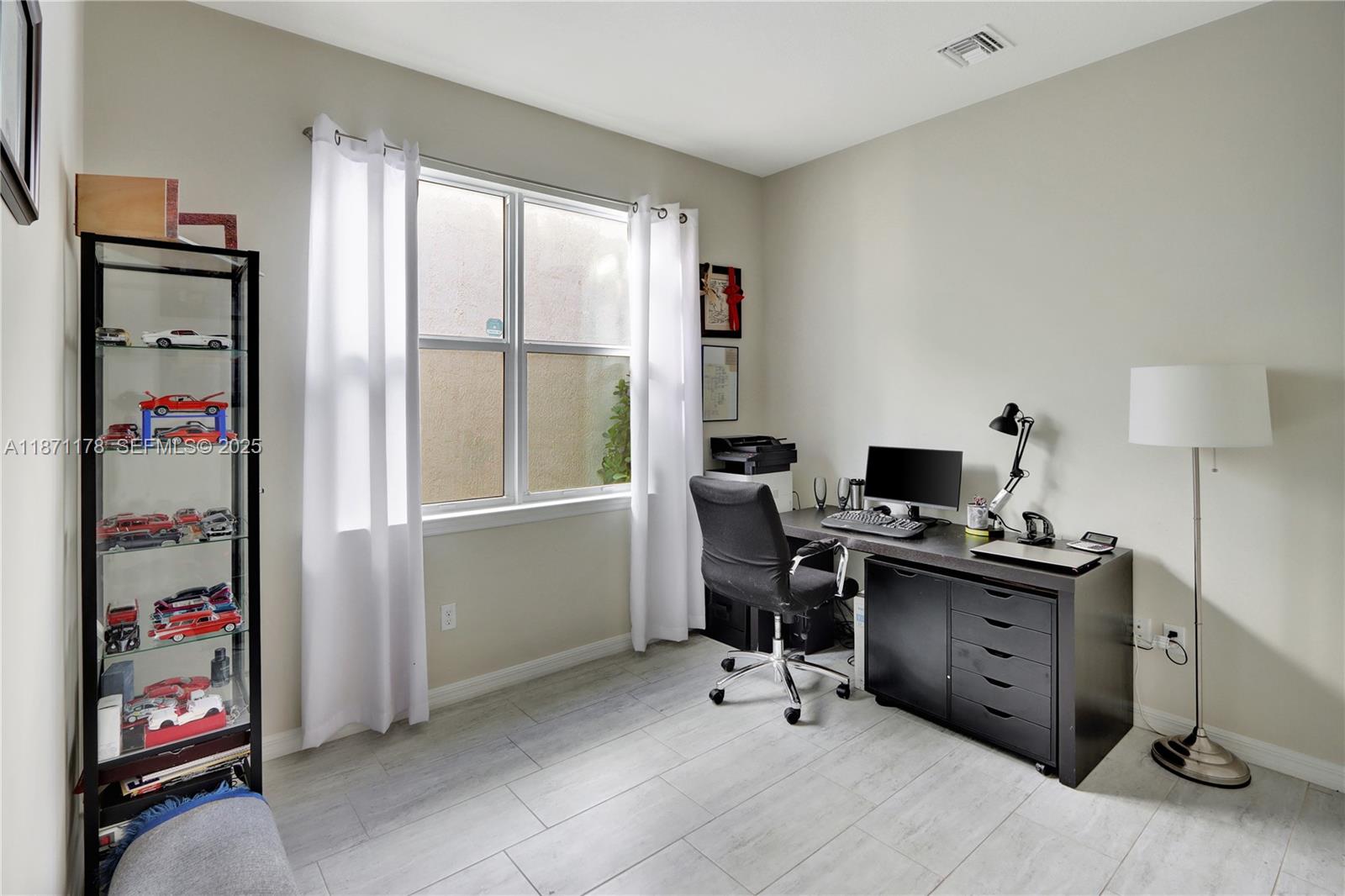 4353 Large Leaf Lane Hollywood, FL 33021 - Photo 14 of 31 a view of a workspace with furniture and a window
