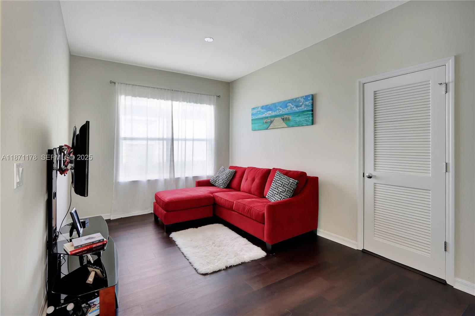 4353 Large Leaf Lane Hollywood, FL 33021 - Photo 16 of 31 a living room with furniture a flat screen tv and a window