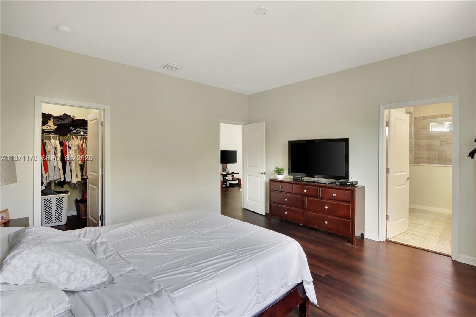 4353 Large Leaf Lane Hollywood, FL 33021 - Photo 19 of 31 a bedroom with a bed and a flat screen tv