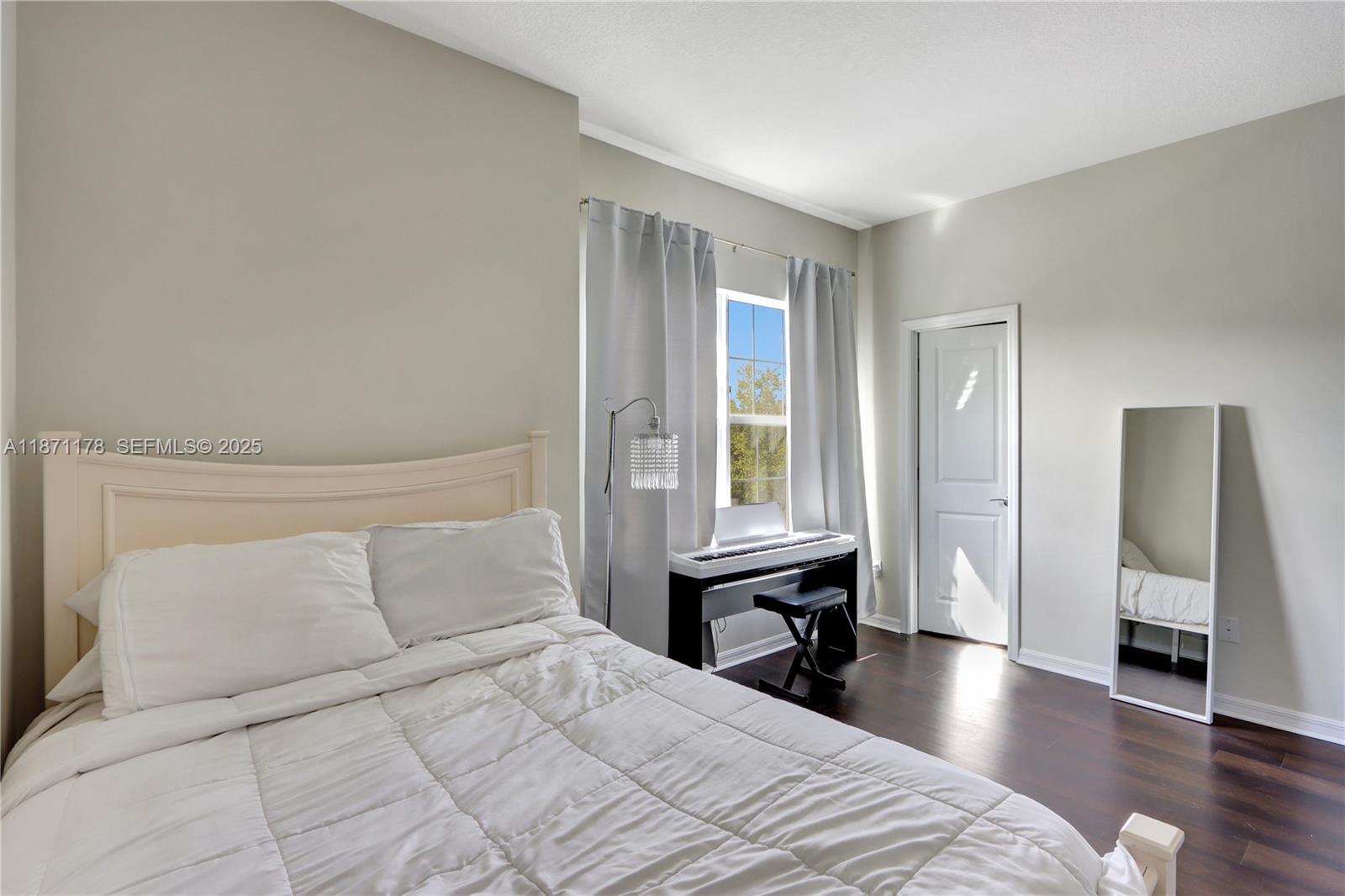 4353 Large Leaf Lane Hollywood, FL 33021 - Photo 25 of 31 a bedroom with a bed and a window