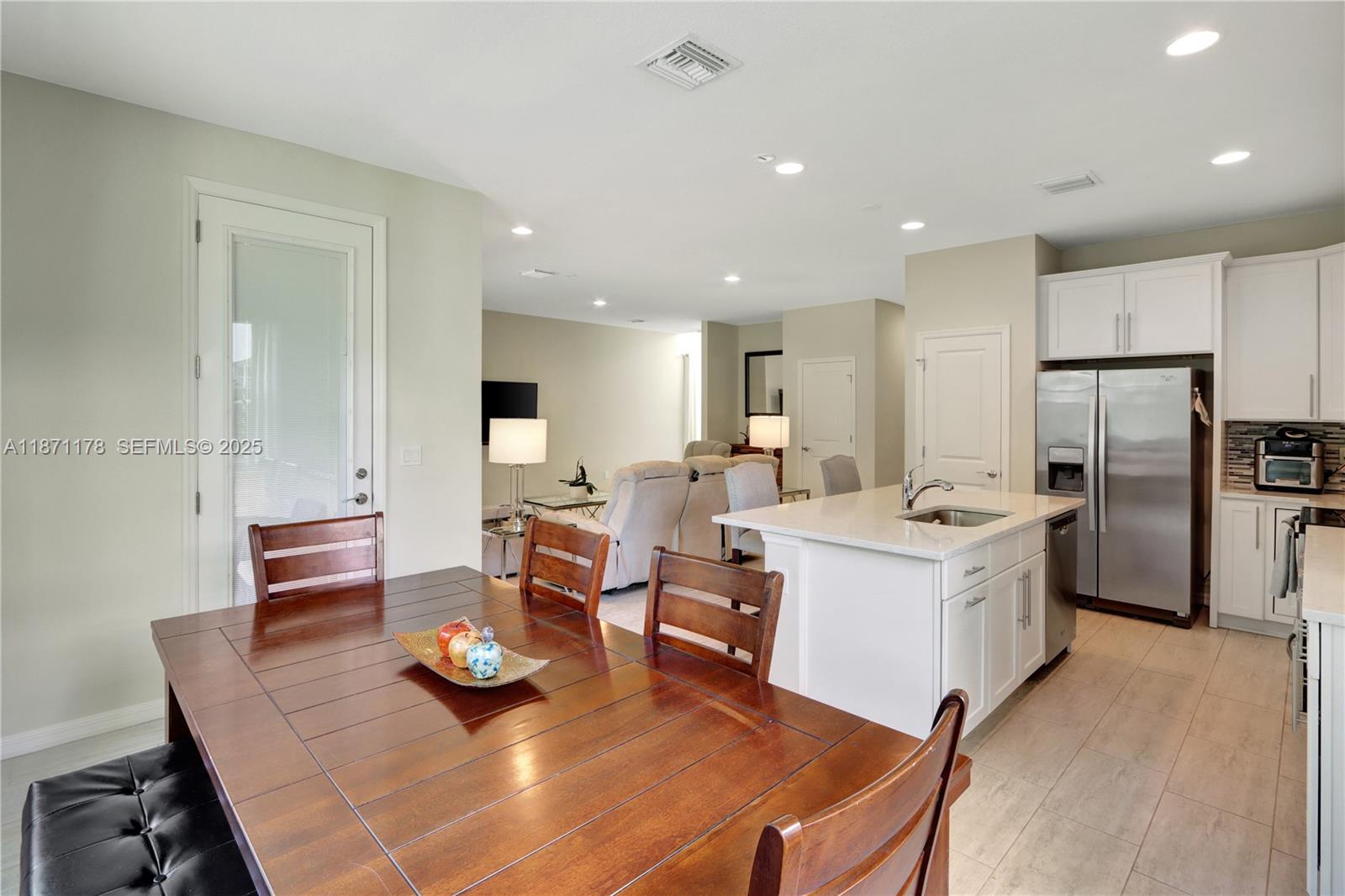 4353 Large Leaf Lane Hollywood, FL 33021 - Photo 8 of 31 a large kitchen with a table and chairs