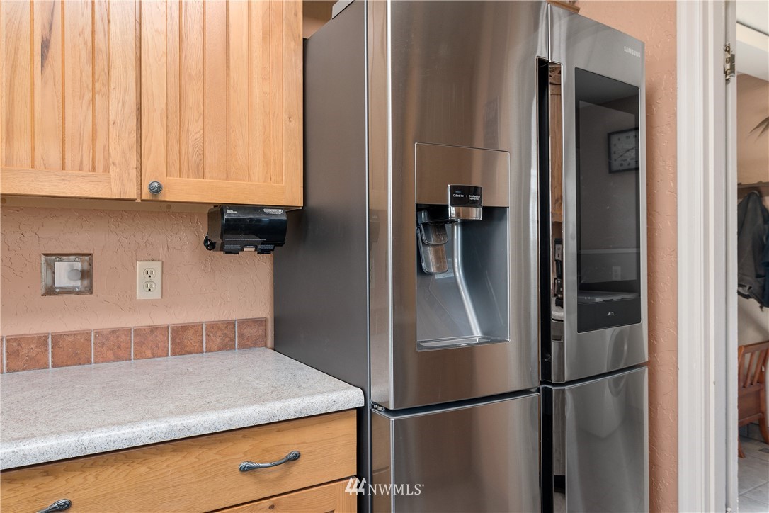 340 Bunker Hill Road Longview, WA 98632 - Photo 9 of 35 a kitchen with a refrigerator and cabinets