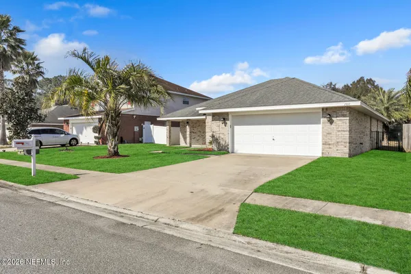 a front view of house with yard and green space