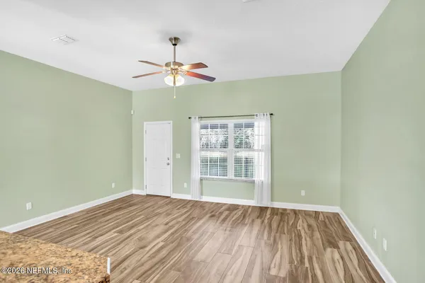 wooden floor in an empty room with a window