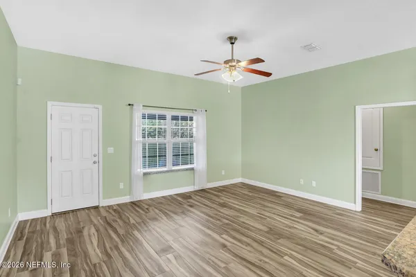wooden floor in an empty room with a window