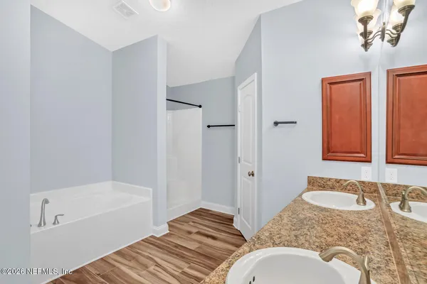 a bathroom with a granite countertop sink and mirror