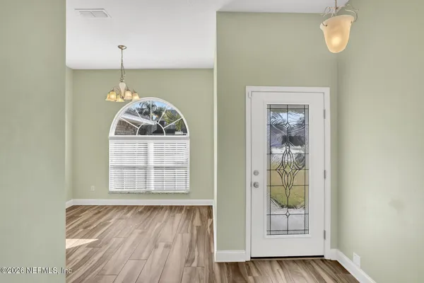 a view of a room that has a bed and a window in it