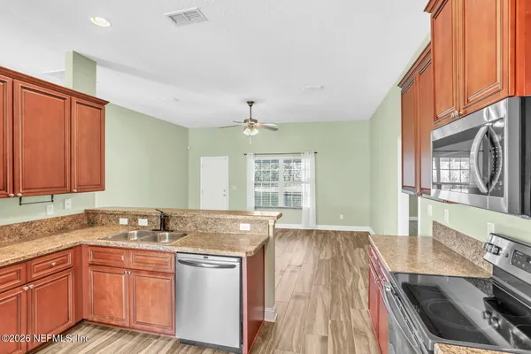 a kitchen with a sink stove and cabinets