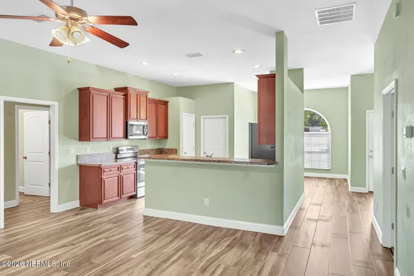 a kitchen with stainless steel appliances granite countertop a refrigerator and a sink