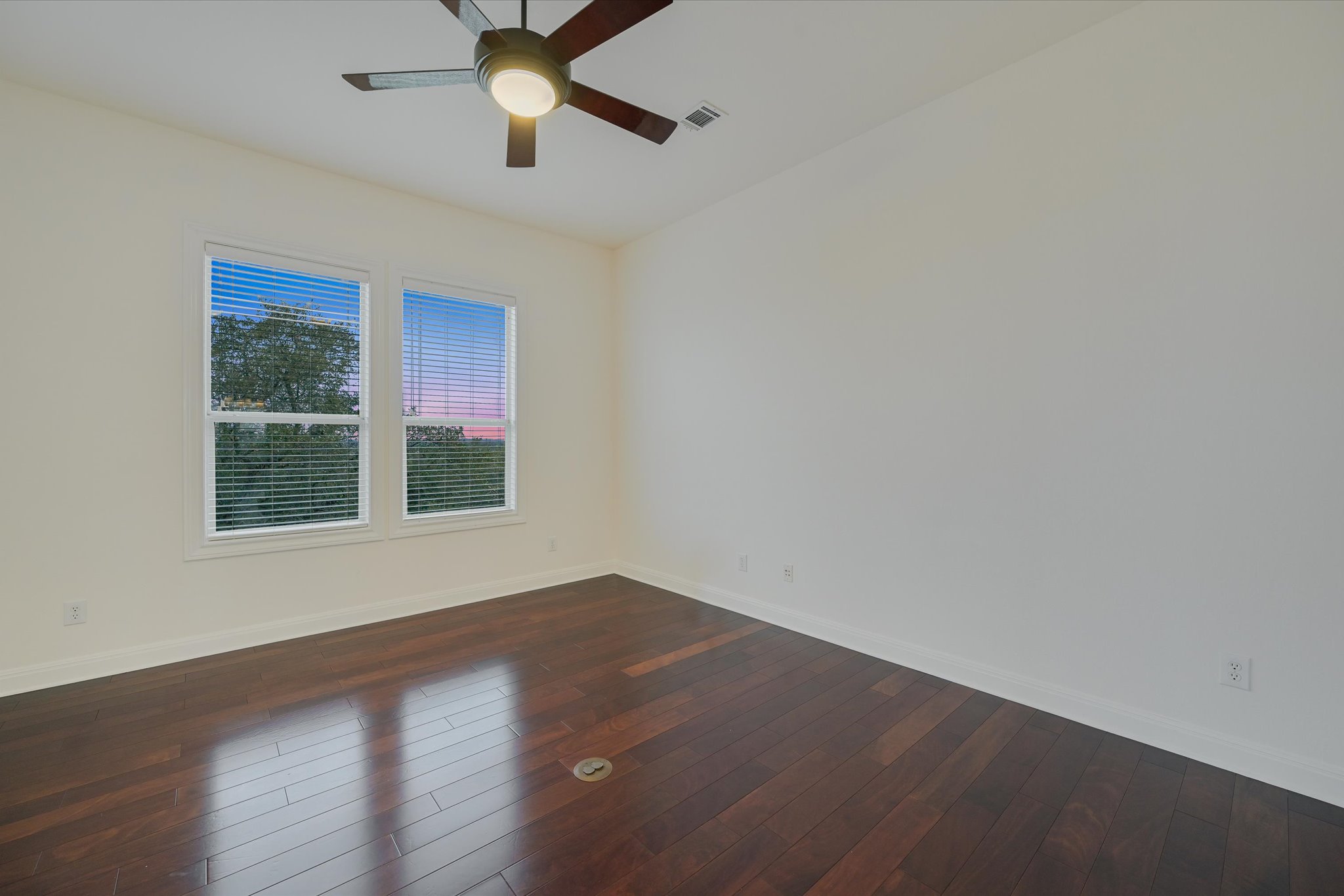 4319 Rum Runner Road Austin, TX 78734 - Photo 16 of 40 an empty room with wooden floor and windows