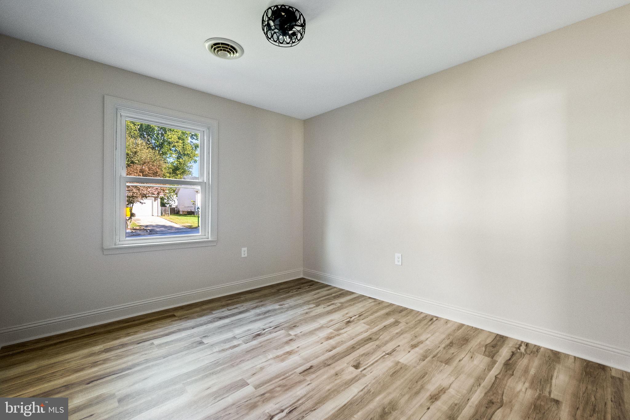 178 Fulton Avenue Charles Town, WV 25414 - Photo 17 of 30 a view of an empty room with wooden floor and a window