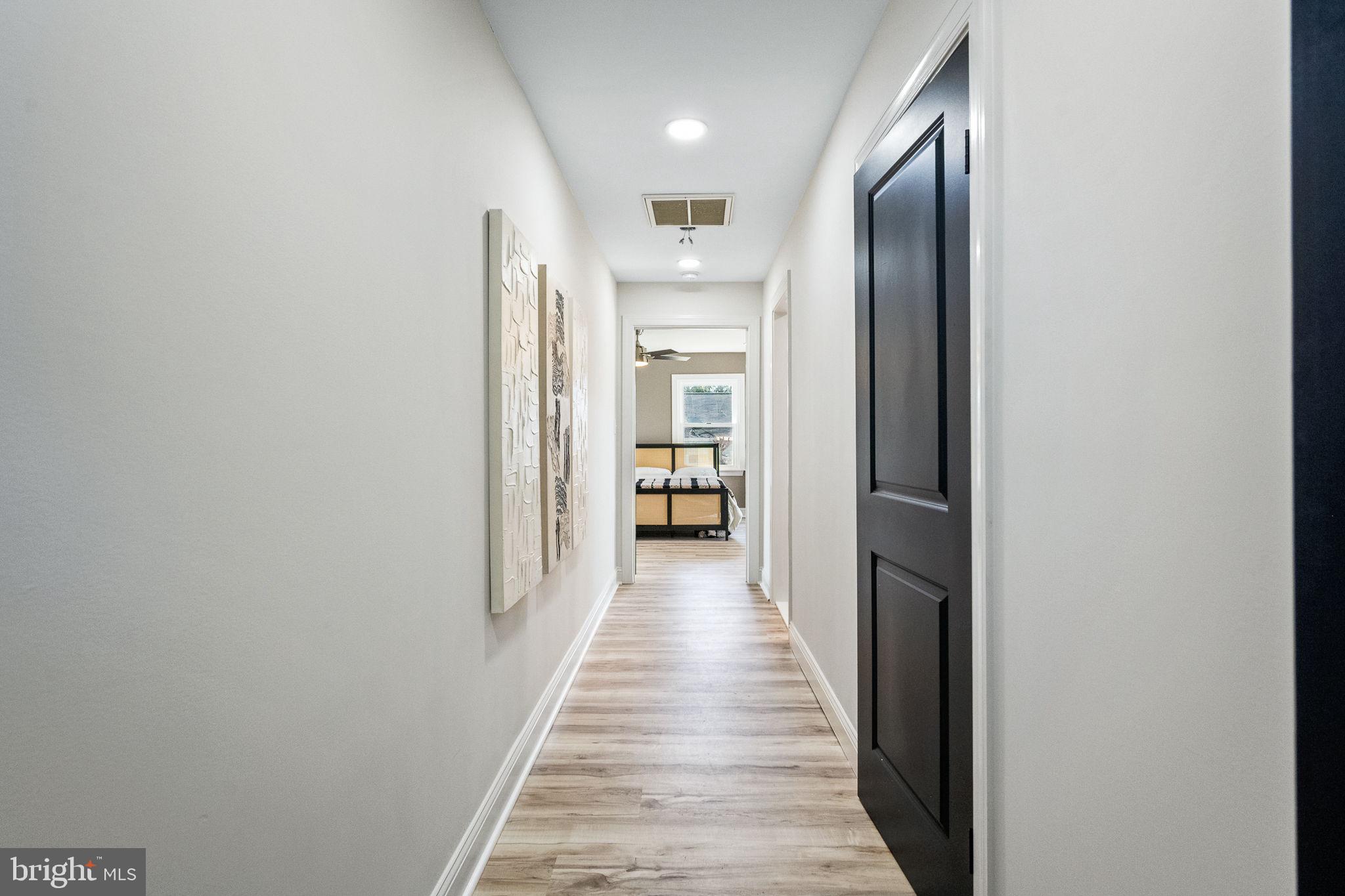 178 Fulton Avenue Charles Town, WV 25414 - Photo 20 of 30 a view of a hallway with wooden floor and a kitchen