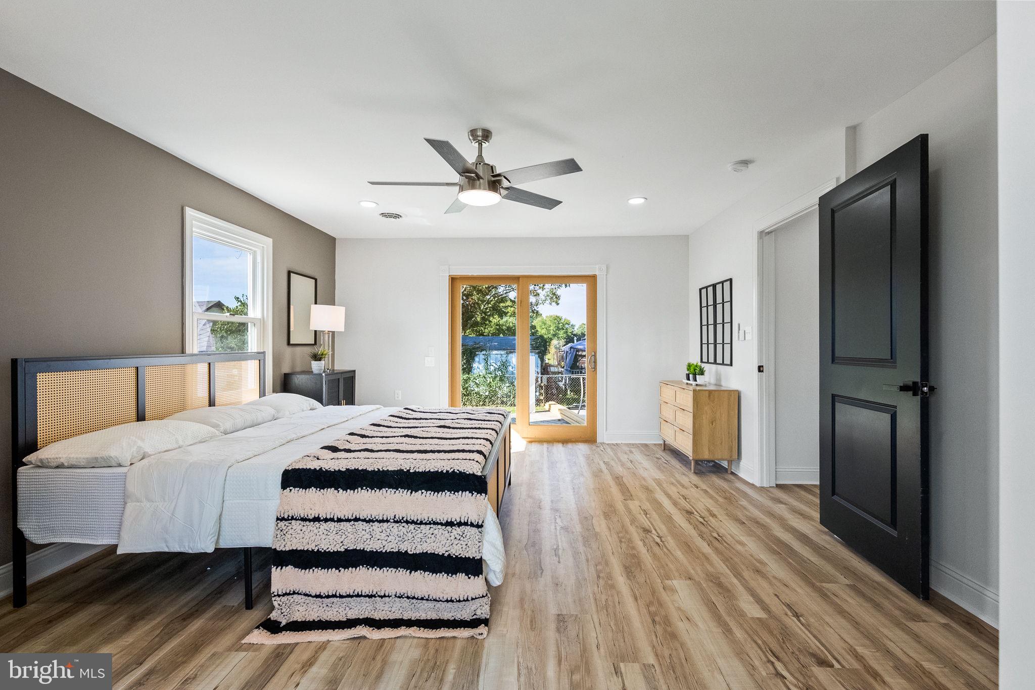 178 Fulton Avenue Charles Town, WV 25414 - Photo 28 of 30 a bedroom with a bed and a large window with wooden floor