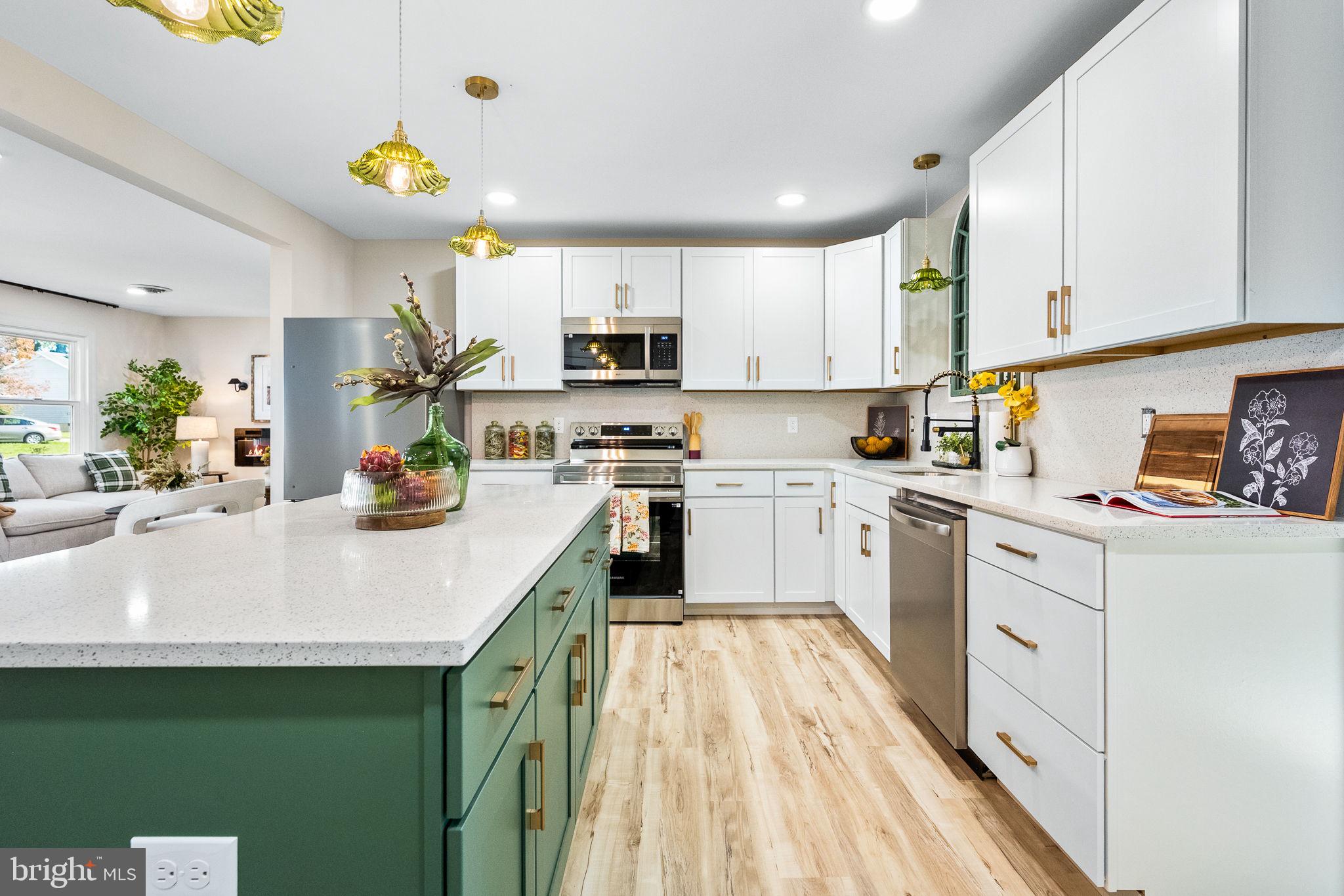 178 Fulton Avenue Charles Town, WV 25414 - Photo 9 of 30 a kitchen with kitchen island granite countertop a sink a stove cabinets and counter space