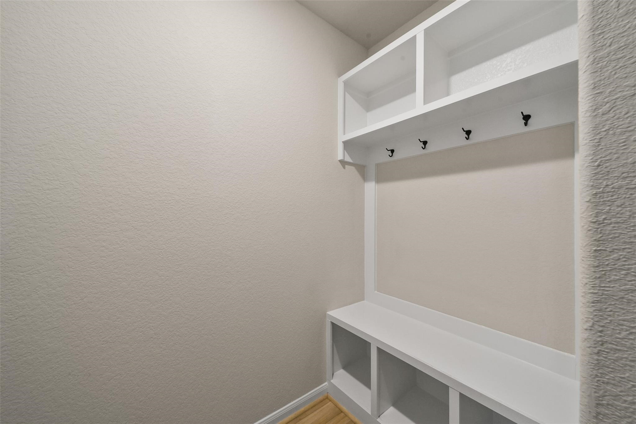 10522 Plumas Run Drive Rosharon, TX 77583 - Photo 25 of 29 Charming, organized mudroom featuring sleek built-in storage and convenient hooks for a clutter-free entryway.