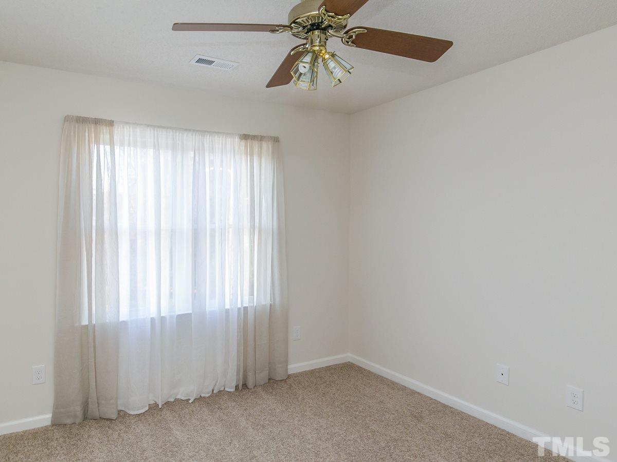 4024 Iron Horse Road Raleigh, NC 27616 - Photo 15 of 25 an empty room with chandelier fan and windows