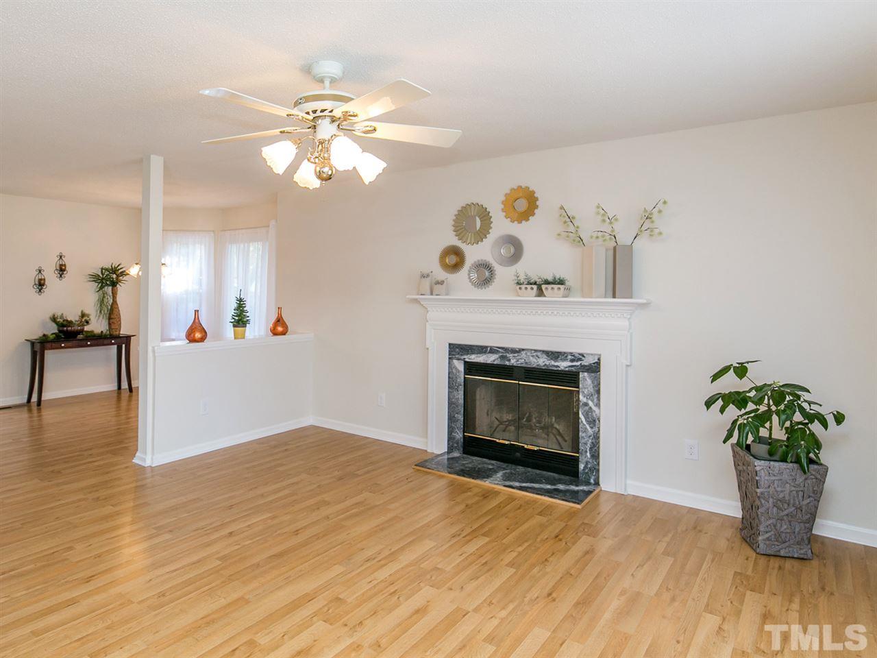 4024 Iron Horse Road Raleigh, NC 27616 - Photo 3 of 25 a living room with furniture and a fireplace