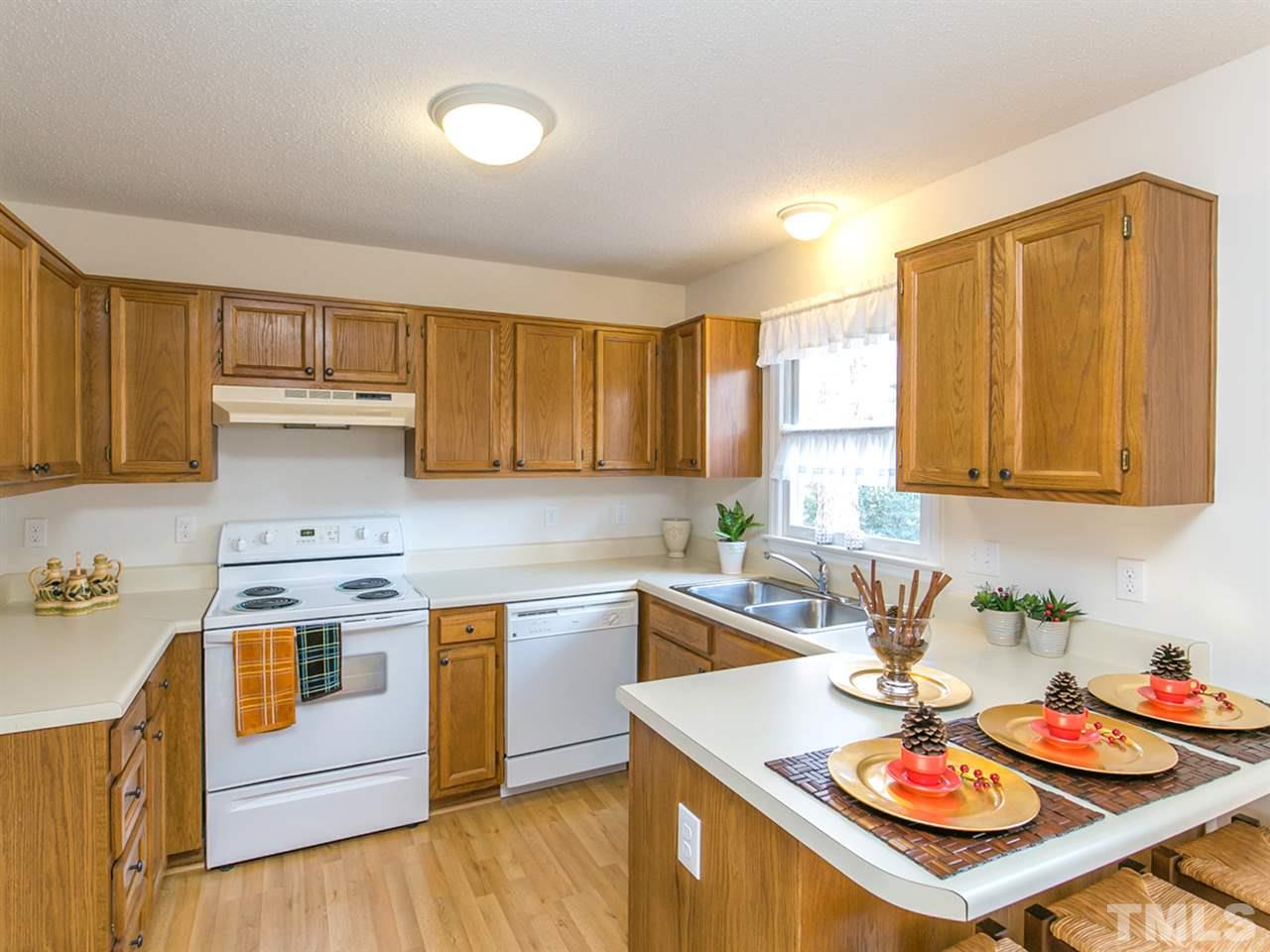 4024 Iron Horse Road Raleigh, NC 27616 - Photo 7 of 25 a kitchen with a sink stove top oven and cabinets