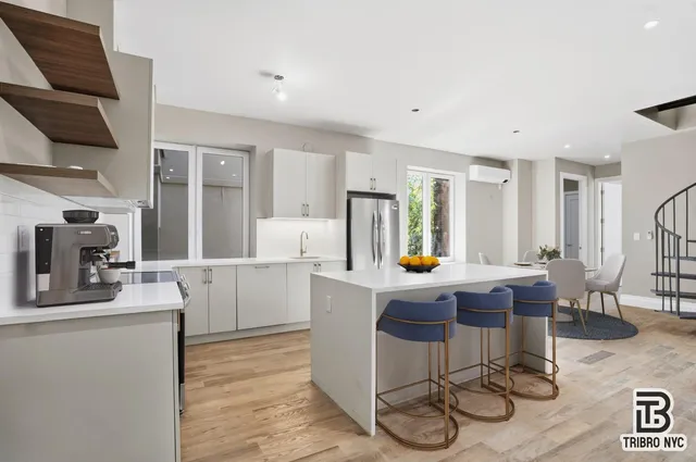 a kitchen with a sink a stove and chairs