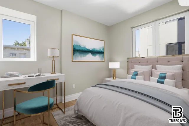 a bedroom with a bed a desk and chair