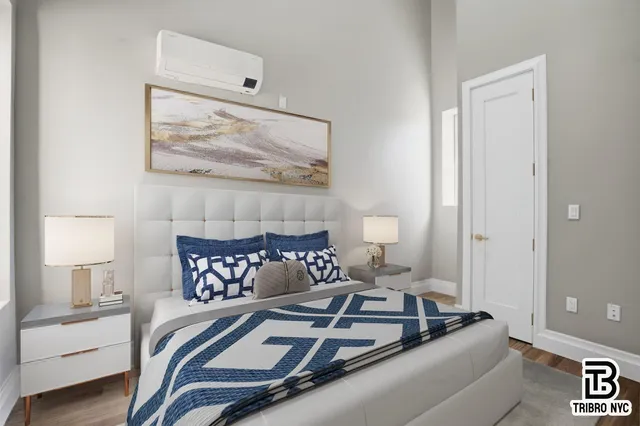 a bedroom with a bed and a painting on the wall