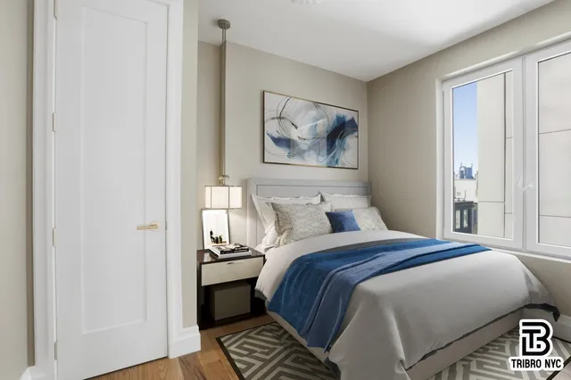 a bedroom with a bed and a painting on the wall