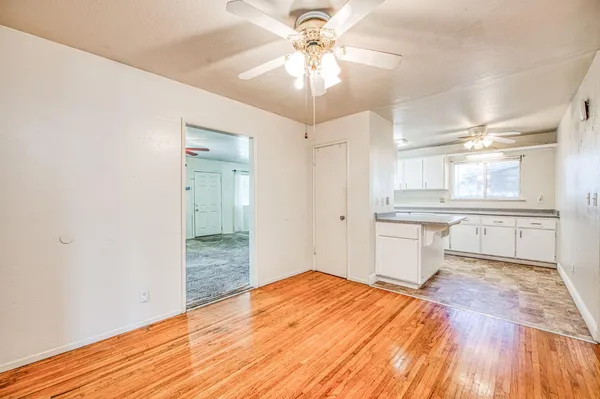 a bedroom with a bed and a chandelier fan