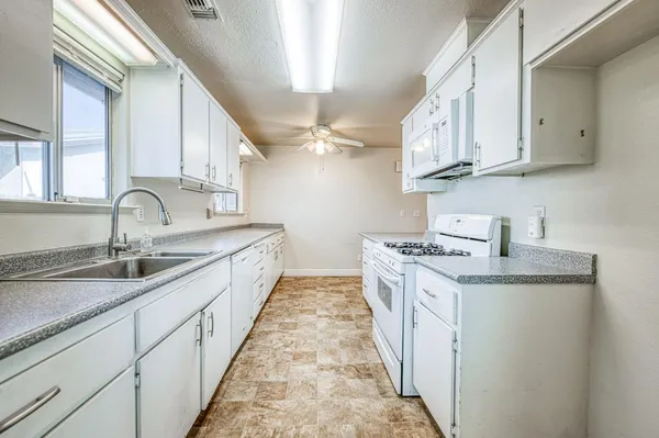 a kitchen with stainless steel appliances granite countertop a sink and cabinets